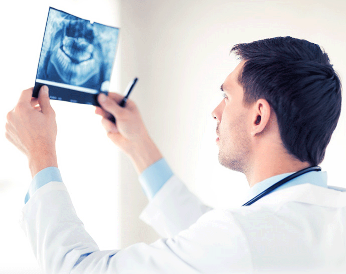 Surgeon looking at teeth x-ray